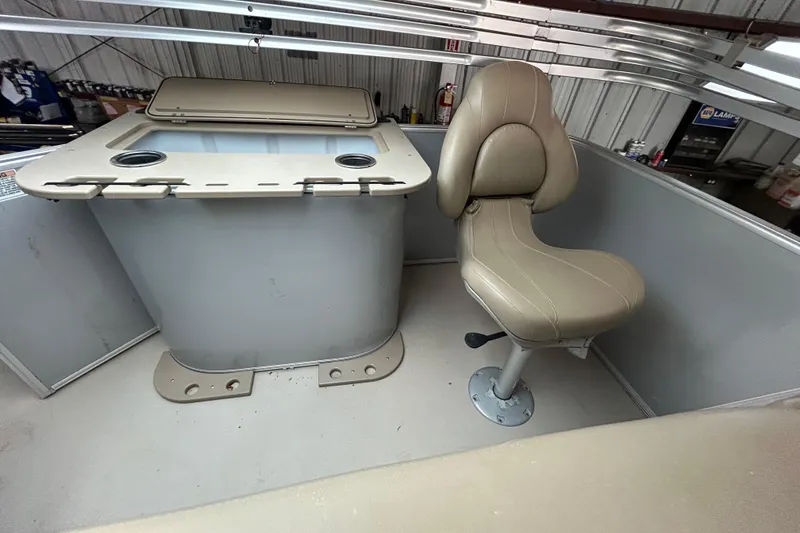 Slide: The Image of 2021 Sylvan Mirage Fish 820 CNF boat interior with beige seating and storage compartment. - 9