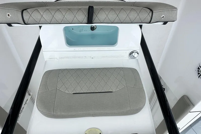 Slide: The Image of 2022 Sportsman Heritage 241 Center Console boat interior with steering wheel and seating. - 12