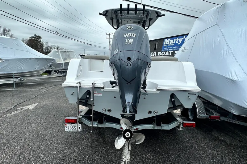 Slide: The Image of 2022 Sportsman Heritage 241 Center Console boat on trailer by waterfront. - 2