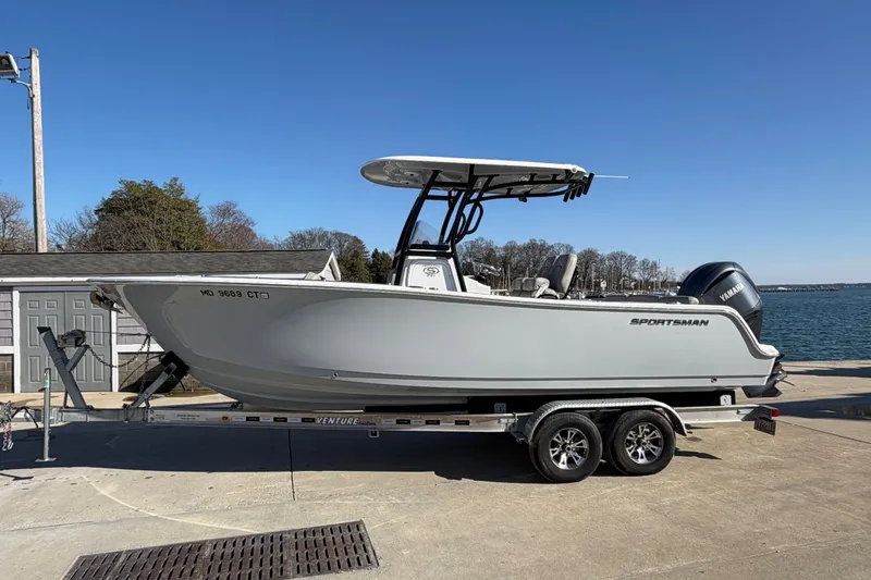 Slide: The Image of 2022 Sportsman Heritage 241 Center Console boat on trailer by waterfront. - 21