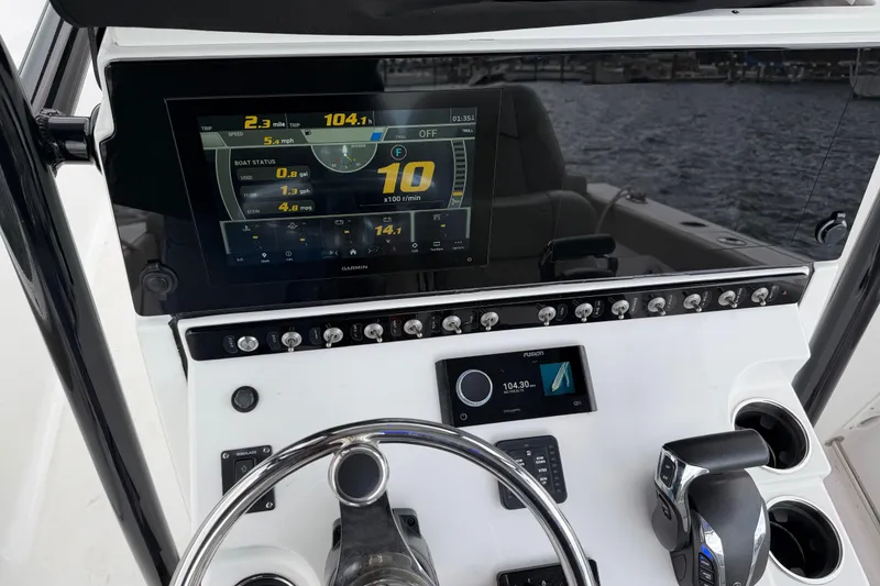 Slide: The Image of 2022 Sportsman Heritage 241 Center Console dashboard with digital display and controls. - 24