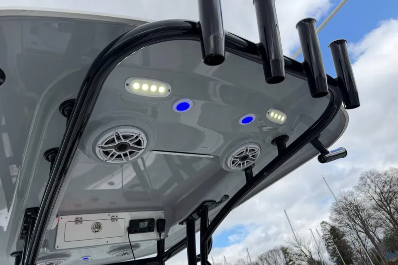 Slide: The Image of 2022 Sportsman Heritage 241 Center Console boat with LED lights and speakers on the T-top. - 29