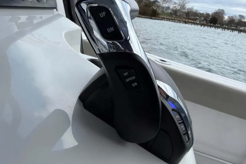 Slide: The Image of Throttle control on 2022 Sportsman Heritage 241 Center Console boat, near water. - 32