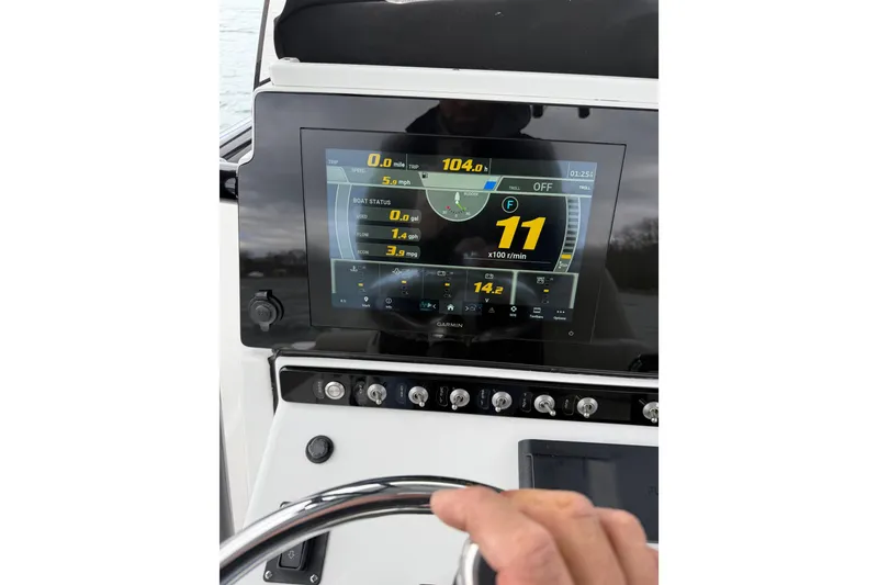 Slide: The Image of 2022 Sportsman Heritage 241 Center Console dashboard with digital display and controls. - 34