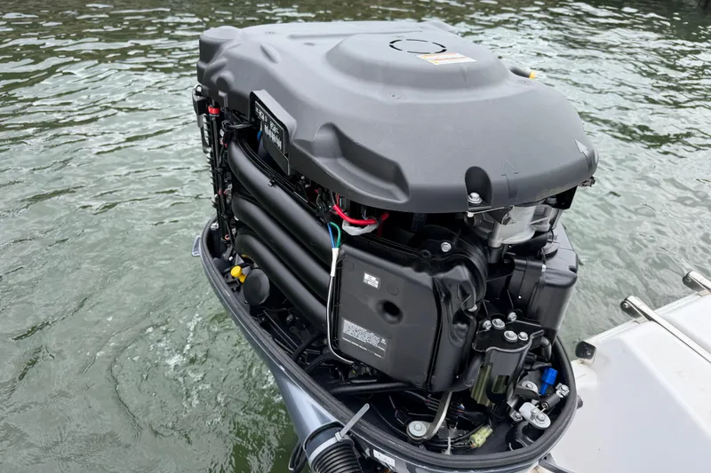 Slide: The Image of Outboard motor of 2022 Sportsman Heritage 241 Center Console on water. - 35