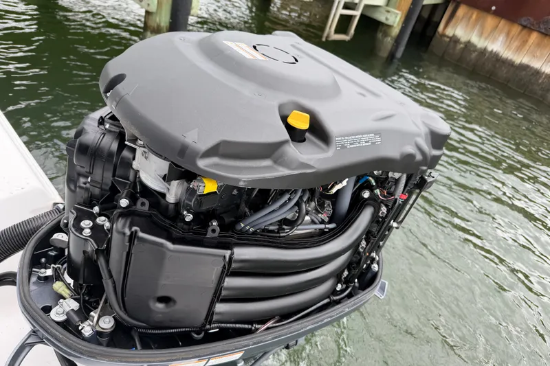 Slide: The Image of Outboard motor of 2022 Sportsman Heritage 241 Center Console on water. - 36