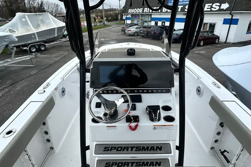 Slide: The Image of 2022 Sportsman Heritage 241 Center Console boat with powerful 300 V6 engine, parked outdoors. - 5