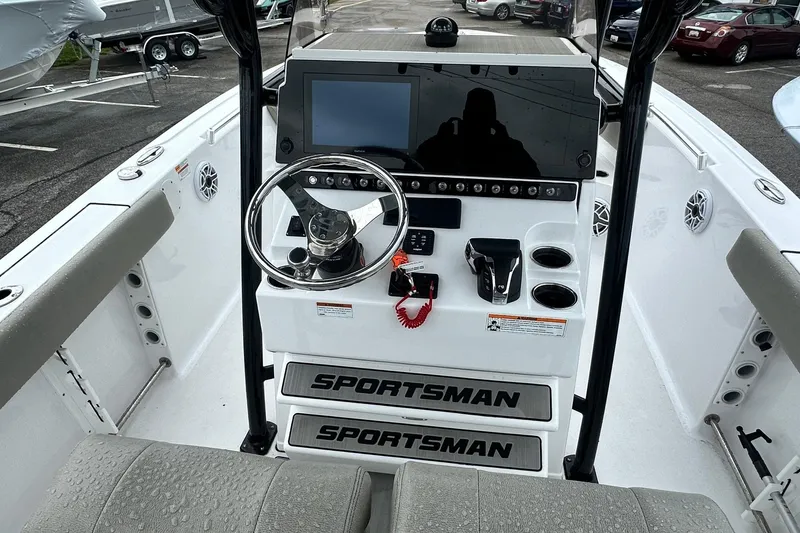 Slide: The Image of 2022 Sportsman Heritage 241 Center Console boat interior with speakers and storage compartment. - 7