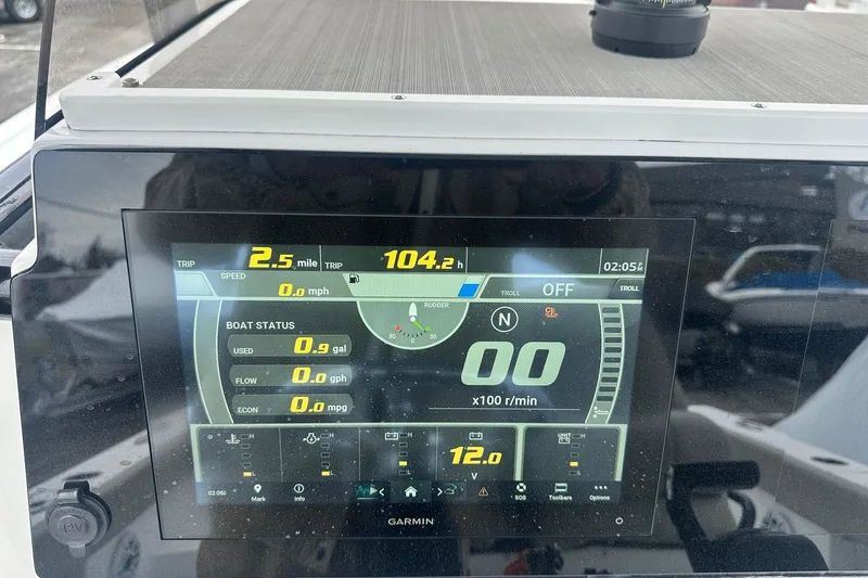 Slide: The Image of 2022 Sportsman Heritage 241 Center Console boat interior with steering wheel and control panel. - 8