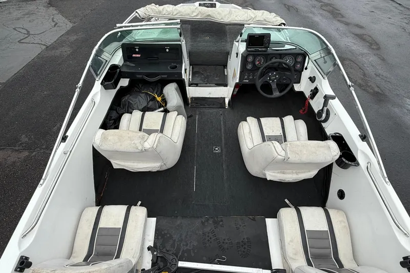 Slide: The Image of Interior of a 1996 Stratos 283 FS boat with white seating and steering console. - 4