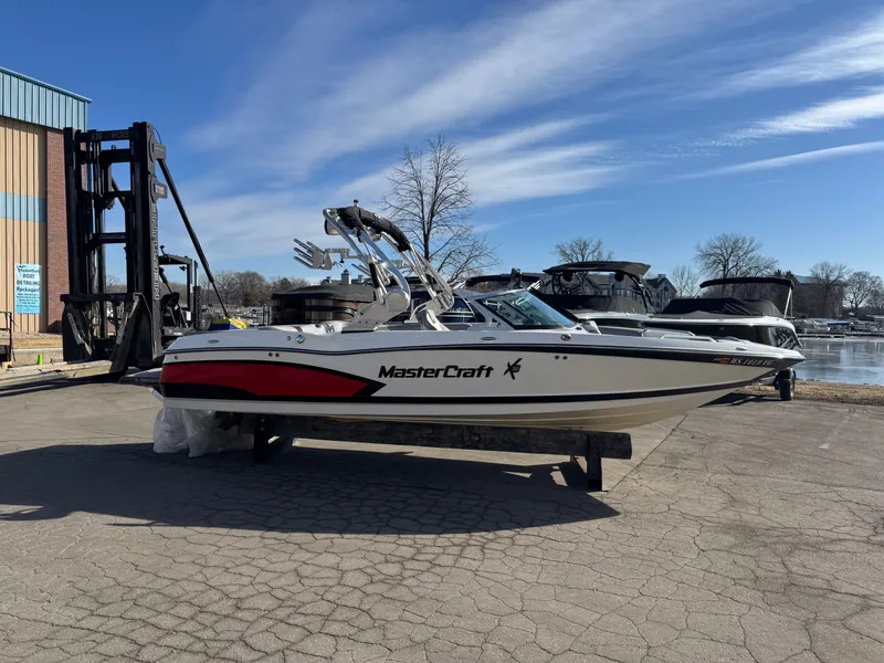 The Image of 2016 MasterCraft X30 boat on a parking lot under sunny skies. - 0