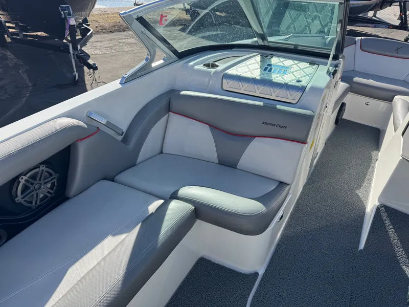 Slide: The Image of Interior of a 2016 MasterCraft X30 boat with gray and white seating. - 10