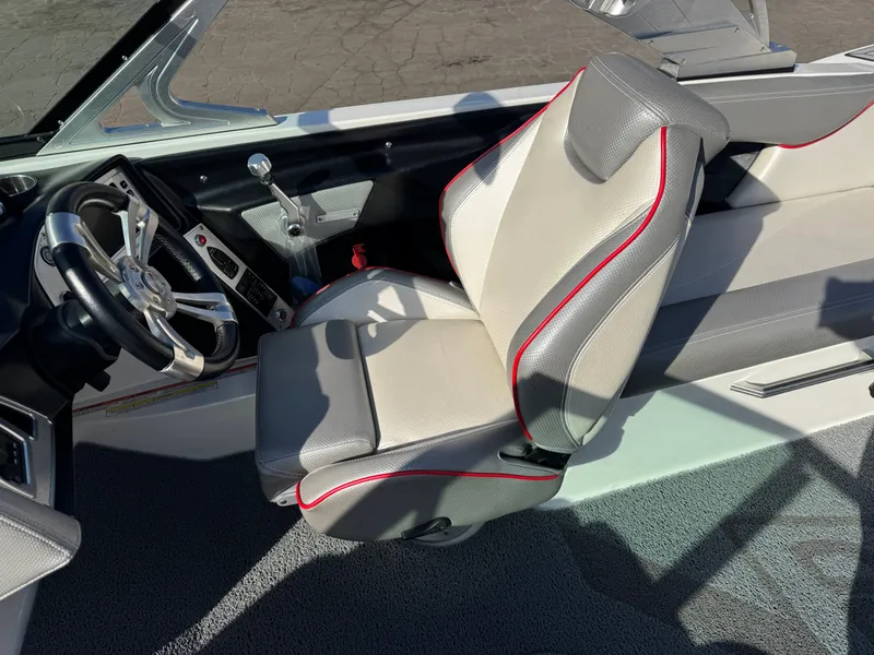 Slide: The Image of Interior of a 2016 MasterCraft X30 boat with steering wheel and seat. - 11