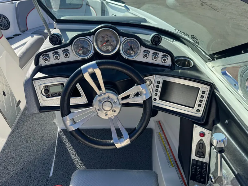 Slide: The Image of Dashboard of a 2016 MasterCraft X30 boat with steering wheel and instruments. - 13