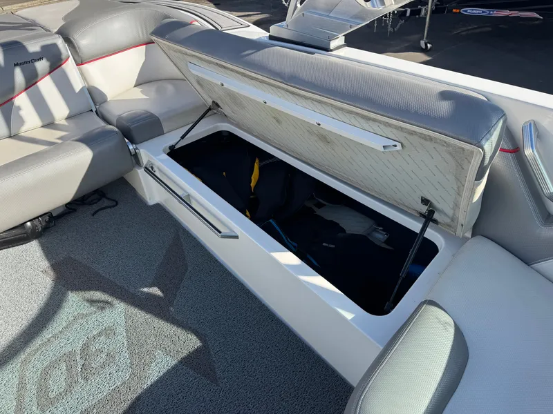 Slide: The Image of 2016 MasterCraft X30 boat with open storage compartment. - 23