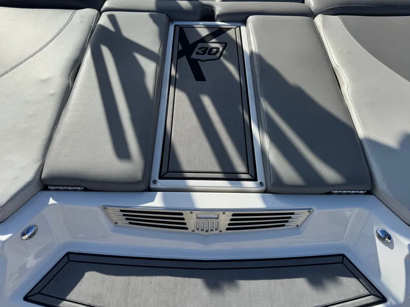 Slide: The Image of 2016 MasterCraft X30 boat rear with gray upholstery. - 28