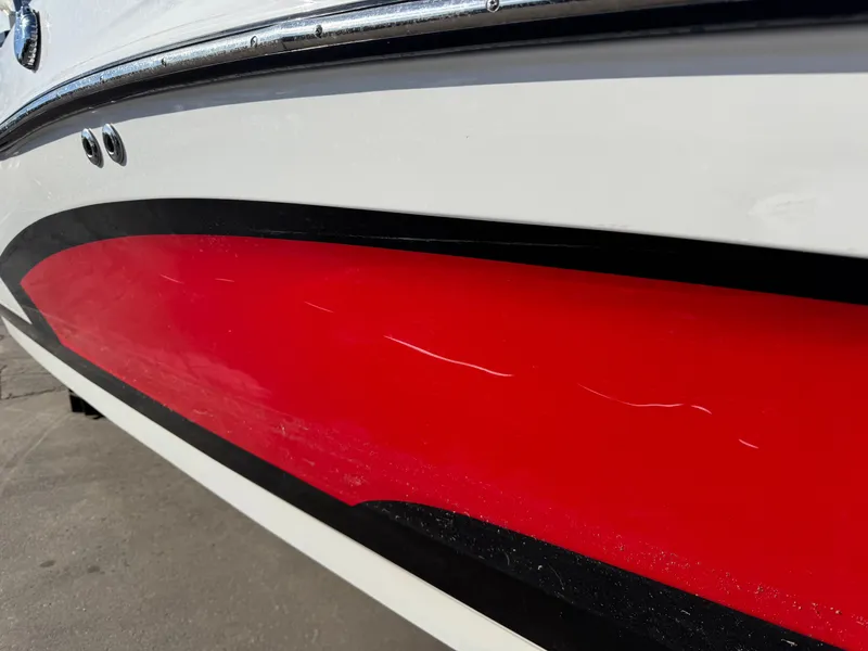 Slide: The Image of Close-up of red hull on a 2016 MasterCraft X30 boat. - 30