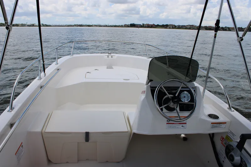 Slide: The Image of Boston Whaler 160 Super Sport 2026: Open cockpit with helm, on calm water. - 29