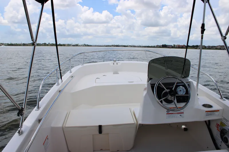 Slide: The Image of Boston Whaler 160 Super Sport 2026 on calm water with clear view and blue sky. - 27