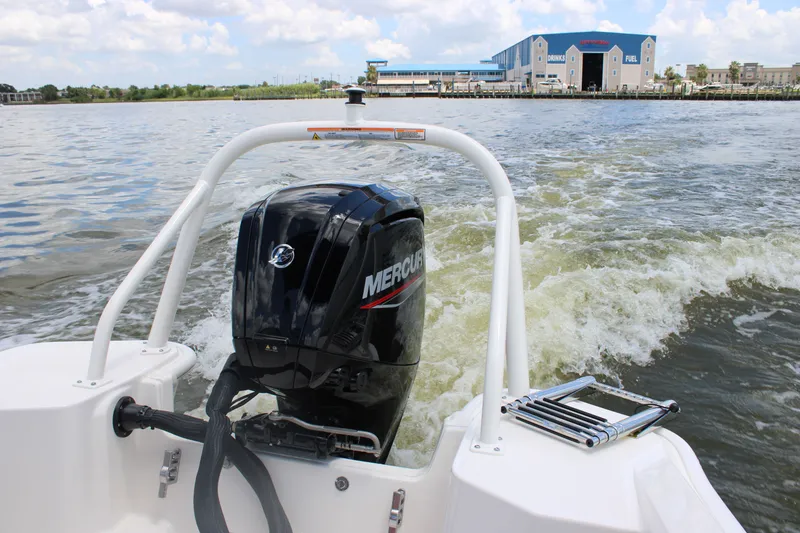 Slide: The Image of Rear view of a Boston Whaler 160 Super Sport with a Mercury engine on calm waters. - 32