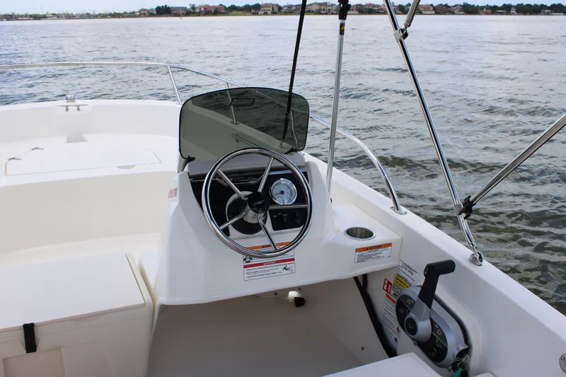 Slide: The Image of The image shows the cockpit of a 2026 Boston Whaler 160 Super Sport. It features a steering wheel and controls. - 28