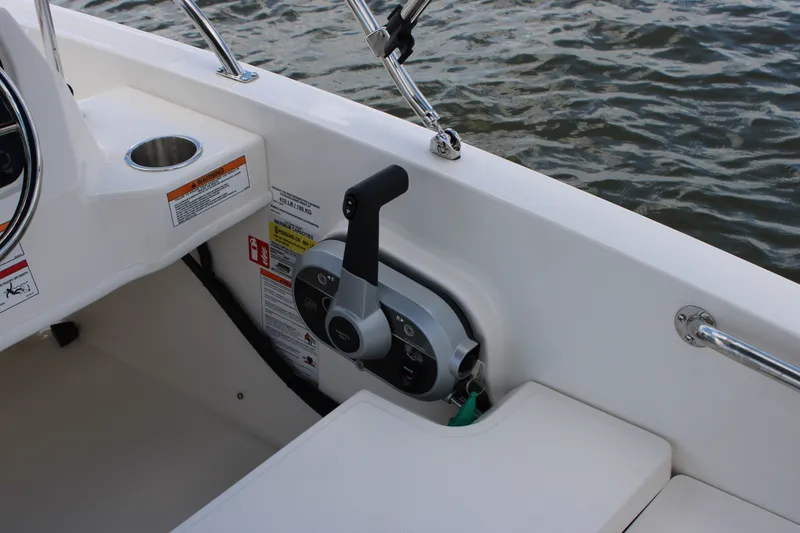 Slide: The Image of Close-up of the helm area on a 2026 Boston Whaler 160 Super Sport with throttle and cup holder. - 26
