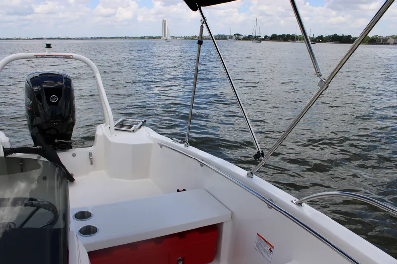 Slide: The Image of The image shows a Boston Whaler 160 Super Sport boat on the water with an outboard motor. - 13