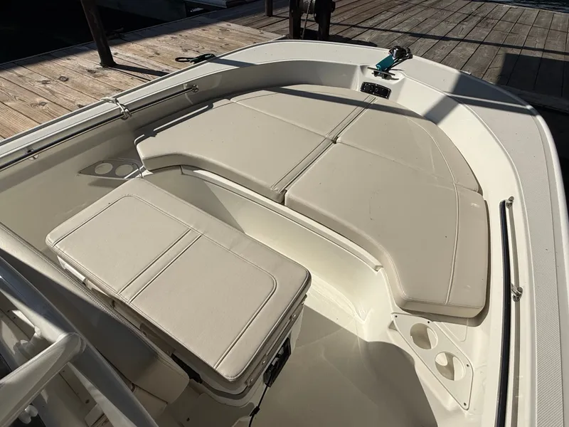 Slide: The Image of The image shows the deck of a Boston Whaler 190 Montauk boat with beige cushions. - 13