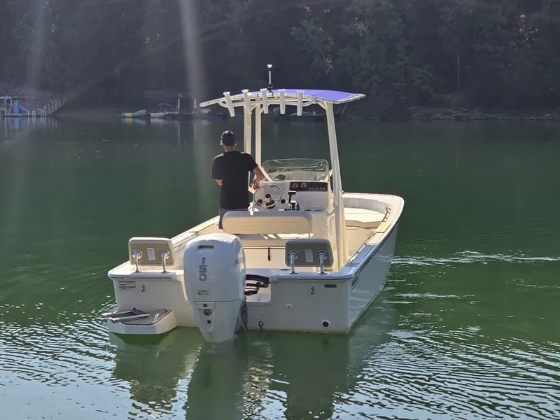 Slide: The Image of A 2026 Boston Whaler 190 Montauk on a calm lake with a person steering. - 21