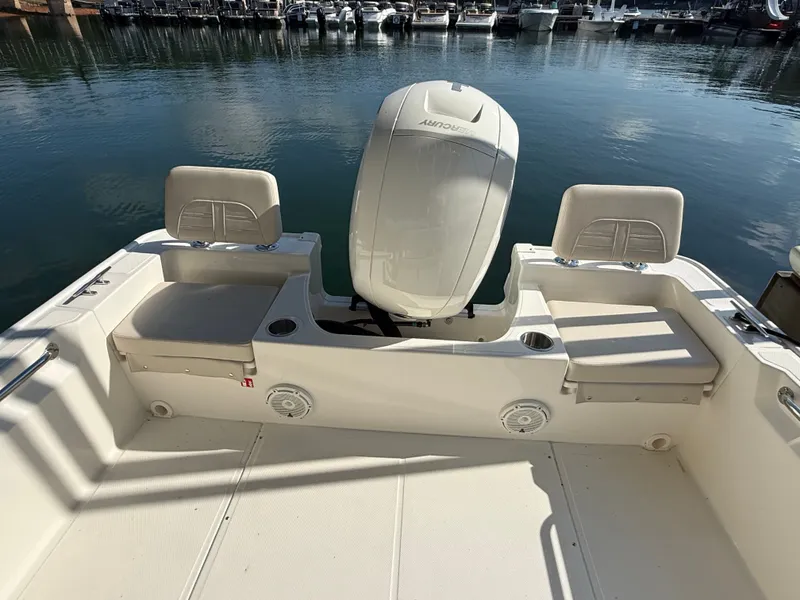 Slide: The Image of The image shows the stern of a Boston Whaler 190 Montauk with an outboard motor and seating. - 7