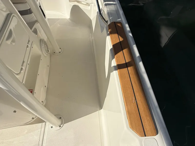 Slide: The Image of The image shows the deck of a Boston Whaler 190 Montauk with wood accents and white surfaces. - 12