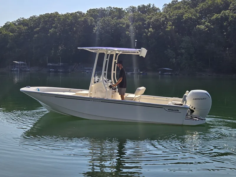 Slide: The Image of A 2026 Boston Whaler 190 Montauk cruising on a calm lake. - 18