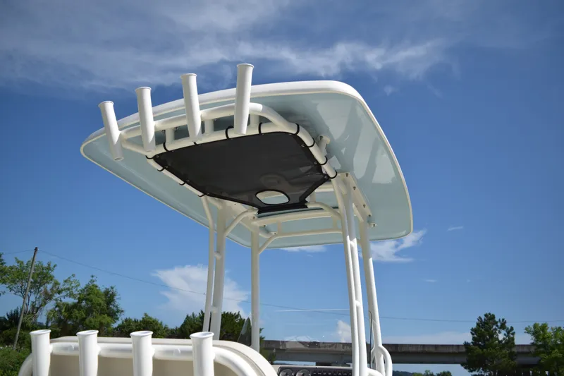 Slide: The Image of The image shows the T-top of a Boston Whaler 210 Montauk with rod holders under a blue sky. - 6