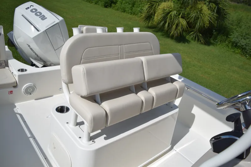 Slide: The Image of The image shows the seating area of a Boston Whaler 210 Montauk with beige upholstery. - 10