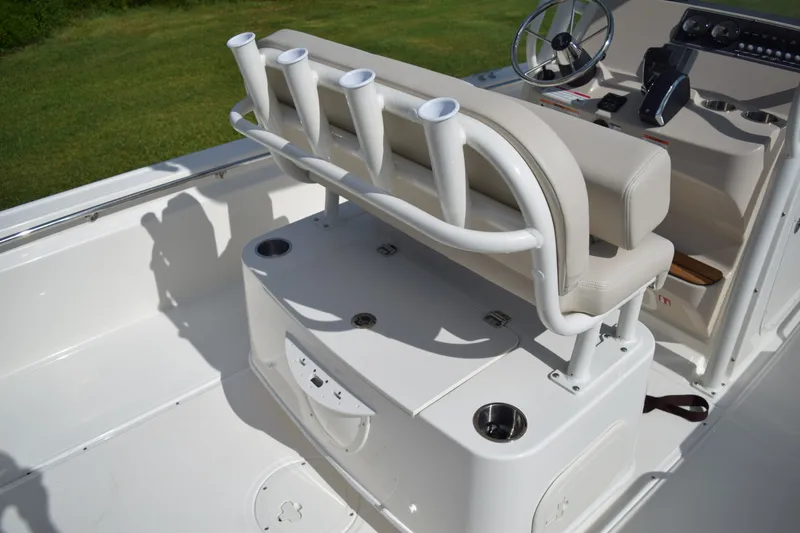Slide: The Image of The image shows the cockpit of a Boston Whaler 210 Montauk with a bench seat and rod holders. - 12