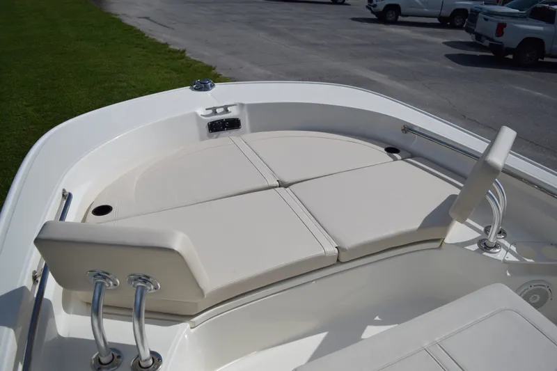 Slide: The Image of The image shows the bow area of a Boston Whaler 210 Montauk with cushioned seating. - 18