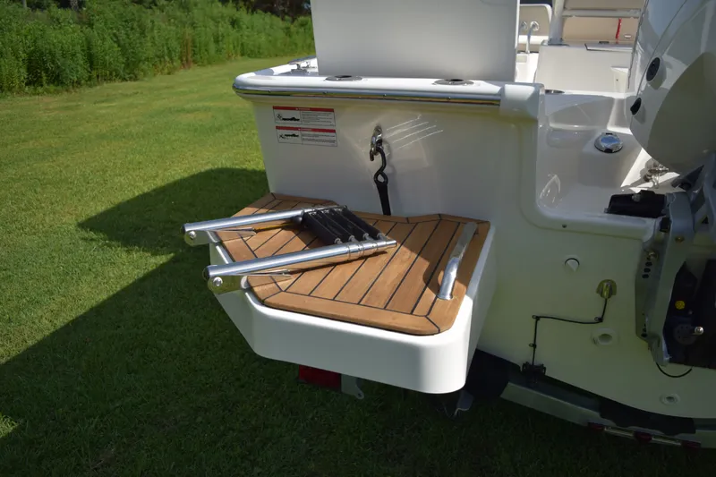 Slide: The Image of The image shows the stern of a Boston Whaler 210 Montauk with a foldable swim ladder. - 3