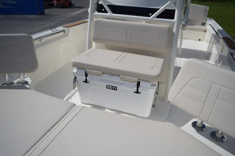 Slide: The Image of The image shows the cockpit of a Boston Whaler 210 Montauk with beige upholstery and a Yeti cooler. - 16