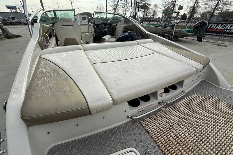 Slide: The Image of 2007 Sea Ray 210 Dual Console boat with worn upholstery and spacious seating area. - 12
