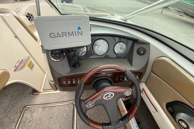 Slide: The Image of 2007 Sea Ray 210 Dual Console boat dashboard with Garmin GPS and steering wheel. - 14
