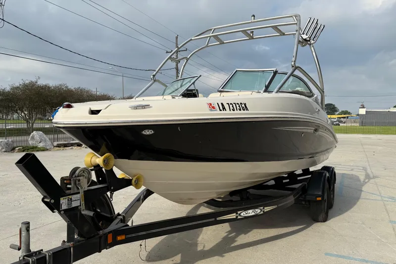Slide: The Image of 2007 Sea Ray 210 Dual Console boat on trailer, parked outdoors. - 3