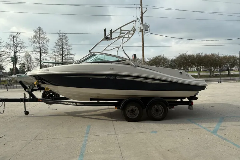 Slide: The Image of 2007 Sea Ray 210 Dual Console boat on trailer, parked outdoors. - 4