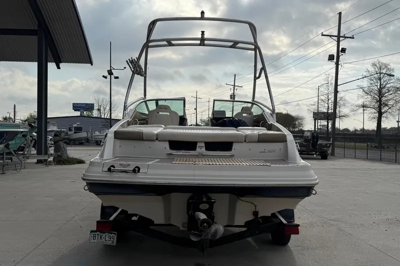 Slide: The Image of 2007 Sea Ray 210 Dual Console boat on trailer, parked outdoors under cloudy sky. - 6
