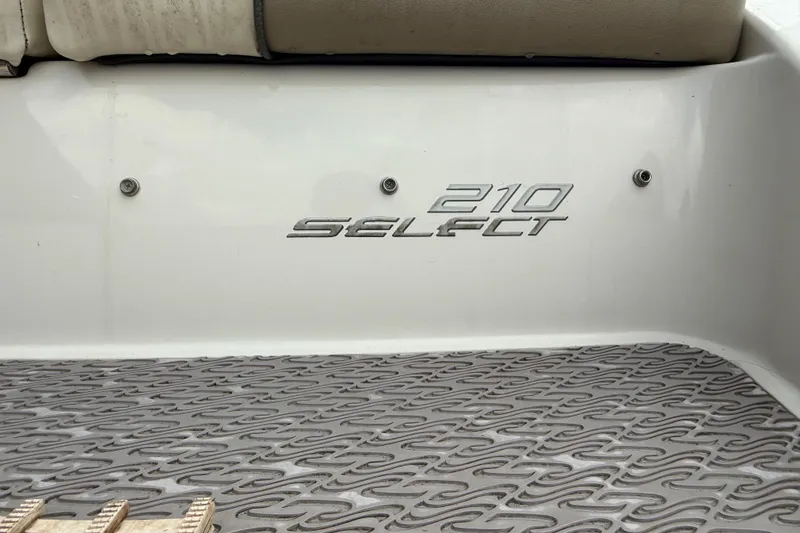 Slide: The Image of 2007 Sea Ray 210 Dual Console boat with "210 Select" branding on deck. - 8