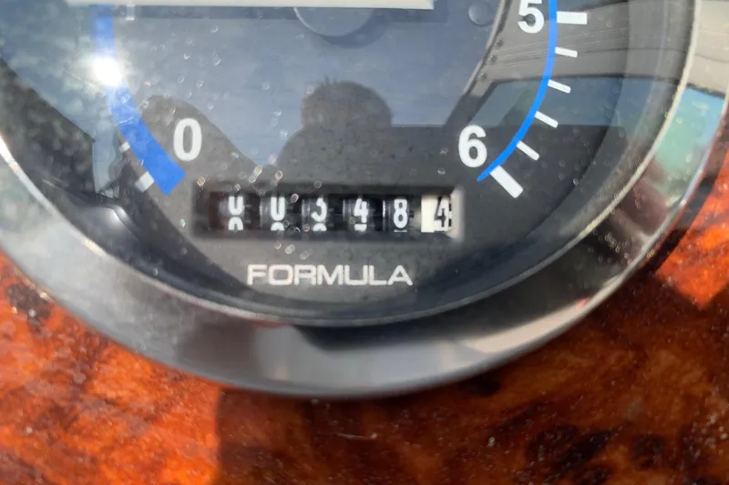 Slide: The Image of Close-up of a 2004 Formula 260 Bowrider boat gauge displaying 418.4 hours. - 12