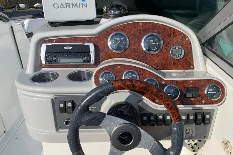 Slide: The Image of 2004 Formula 260 Bowrider dashboard with Garmin GPS and woodgrain paneling. - 3