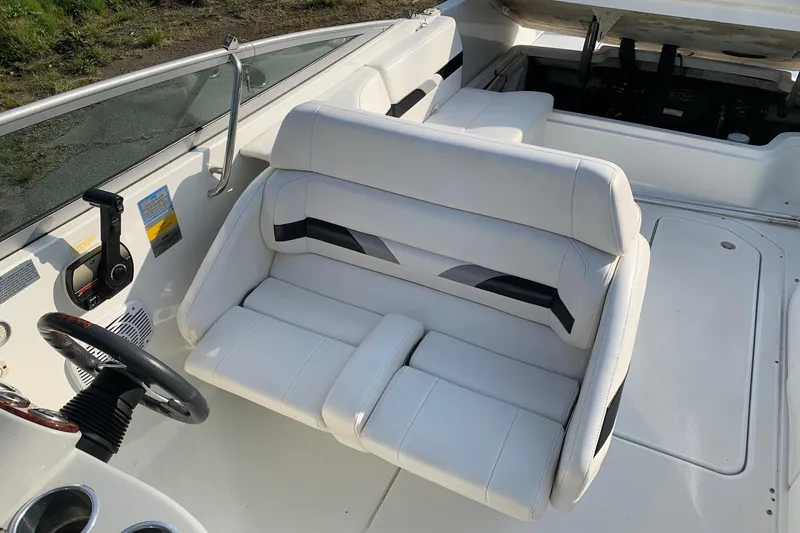 Slide: The Image of 2004 Formula 260 Bowrider interior with white seating and steering wheel. - 4