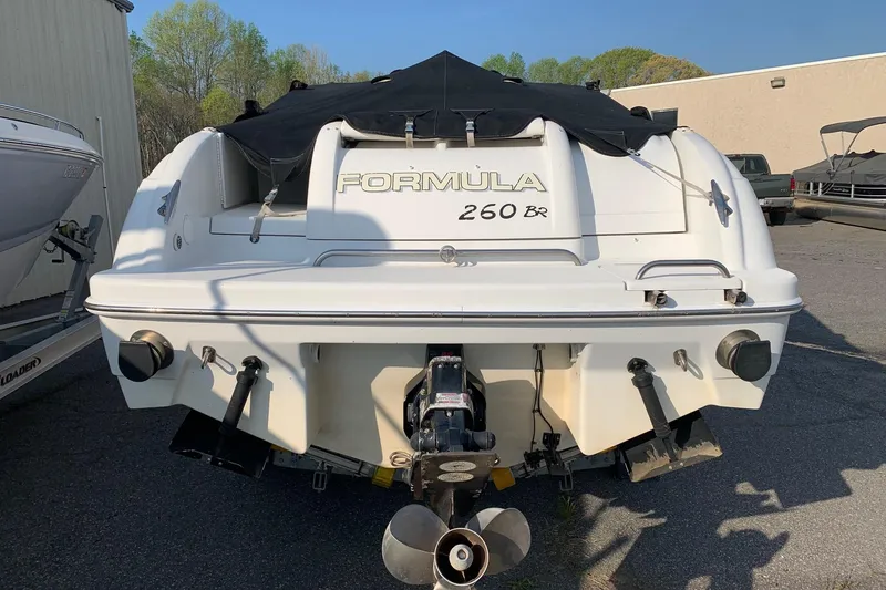 Slide: The Image of 2004 Formula 260 Bowrider boat, rear view, parked outdoors with cover. - 9