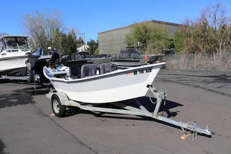 Slide: The Image of 2005 ClackaCraft 16 Drift Boat on trailer in parking lot. - 6