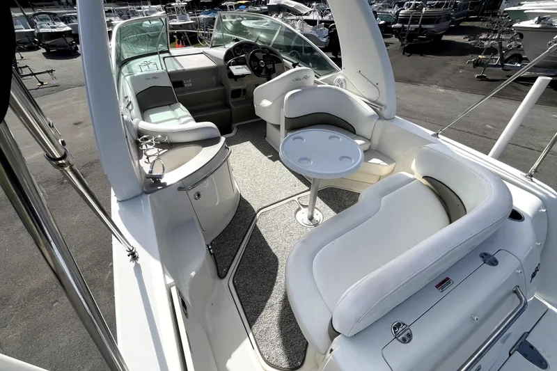 Slide: The Image of 2007 Sea Ray Sundancer 260 boat interior with seating and helm, docked at marina. - 23